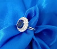 A diamond and sapphire cluster ring, set in 14k white gold, size N.