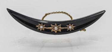 A 9ct gold jet half crescent brooch set with seed pearls, width 70mm.