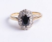 An 18ct yellow gold diamond and sapphire cluster ring, size K.