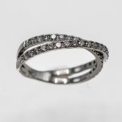 An 18ct diamond two row cross over ring, set in white gold, size N.