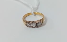 A yellow gold three stone diamond ring (unmarked), size K.