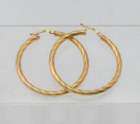 A large pair of 9ct yellow gold twist design hoop earrings, approx 2.84g