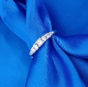 A platinum seven stone diamond set ring, size L/M.