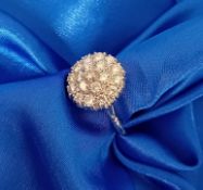 An 18ct white gold diamond cluster ring, (stamped inside the shank 67722, A & W), size N.