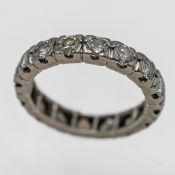 A full diamond eternity ring (not hallmarked), approx 6.5g, size O.