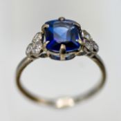 A platinum and blue synthetic corundum and diamond set ring. Centre rectangular cushion blue