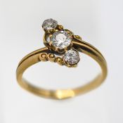 A Victorian diamond 3 stone set ring, 3 x old round cut diamonds set on a slight twist in yellow