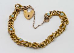 A 9ct yellow gold link bracelet set with nine opals, with heart padlock clip, approx 10.8g