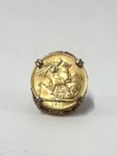 A Geo V full gold sovereign dated 1912, set in a 9ct gold ring mount, approx. total weight 15.54g.