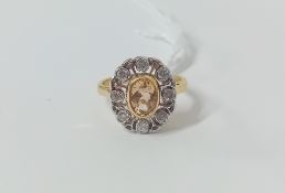An 18ct yellow gold diamond and topaz set ring, size J.