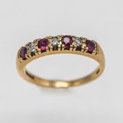 A 9ct yellow gold diamond and ruby seven stone ring, approx 2.3g, size M.