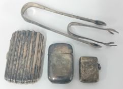 Two silver vesta cases, together with a silver cigarette case, and two sugar tongs, total weight