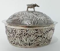A Chinese silver lidded Butter Dish and Stand decorated with bamboos in relief to lid with ‘cow’
