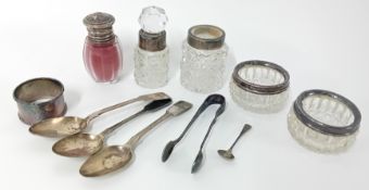 A collection of silver items, to include three teaspoons, sugar tongs, mounted table salts and scent