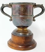 A silver loving cup on a wooden stand, hallmarked Birmingham 1924, total silver weight 5.68oz.