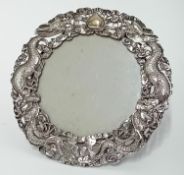 A Chinese silver circular easel Photo Frame, the frame pierced with dragons and flaming pearl by