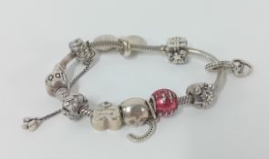 Pandora silver chain with seven charms.