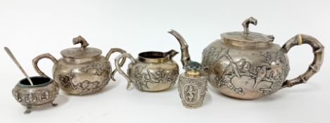 A Chinese silver tea set, with bamboo style handles and embossed cherry blossom decoration, ivory