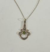 A 9ct yellow gold peridot and seed pearl pendant on gold chain.