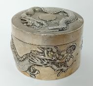 A Chinese silver cylindrical lidded Powder Box with three toed dragon in relief. 9cm diameter, by