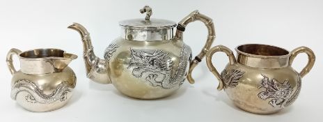 A Chinese silver three-piece Tea Service with three toed dragon in high relief, Luen Wo. 29.47oz.
