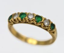 A diamond and emerald half eternity, set in 18ct yellow gold, approx 3g, size L.