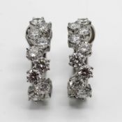Kutchinsky, a pair of diamond set creole hoop earrings with French wire clip fittings. Each set with