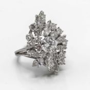 A fine diamond abstract design multi stepped ring with centre modern brilliant cut diamond