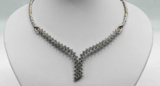 Kutchinsky, an elegant diamond ‘V’ shape necklace, twist design set with 73 round and brilliant