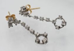 A pair of diamond drop earrings, each set with seven round cut diamonds, set with butterfly