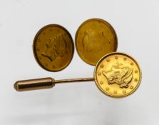 A three-piece USA 1853 gold dollar set (tie pin & earrings), 6g.