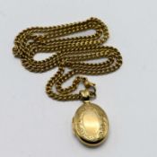 A 9ct curb link necklace with a 9ct oval and chased decorated locket, 23.8g (Bruford's Jewellers