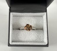 A handmade ring, with diamonds and a Rose, set in 9ct white gold, size M.