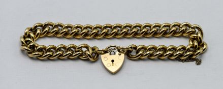 A 9ct yellow gold curb link bracelet and padlock, 28.5g.