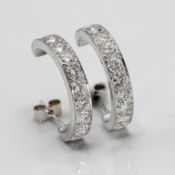 A pair of classic half hoop diamond set earrings, set with 10 modern brilliant cut diamonds stud