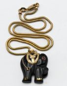 A yellow gold elephant pendant assessed as Tortoiseshell with a single round cut Ruby eye