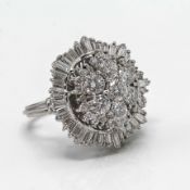 A fine diamond cluster ring set with a mixed arrangement of round cut and baguette cut diamonds, set