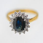 A sapphire and diamond cluster ring, set in 18ct yellow gold, approx 4.9g, size L/M.