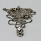 An 18ct white gold contemporary style necklace and pendant set with small baguette cut diamonds, 6.