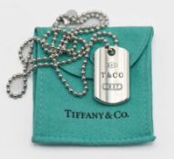 A Tiffany dog tag pendant and necklace in silver. Marked '925 T & CO 1837'. 29g, with pouch,