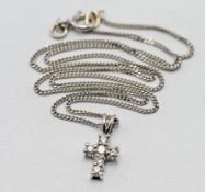 A diamond cross pendant and chain, set in 18ct white gold, colour G-H, clarity VS-SI, length of