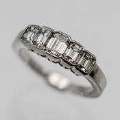 A good diamond 5 stone ring set with graduated emerald cut diamonds, mounted in a platinum rub
