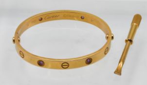 Cartier, an 18ct gold Love bangle set from the Leve Collection, set with pink sapphires, marked 750,