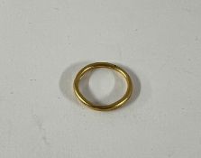A 22ct yellow gold wedding ring split into two rings in a twist shape, approx 2.80g