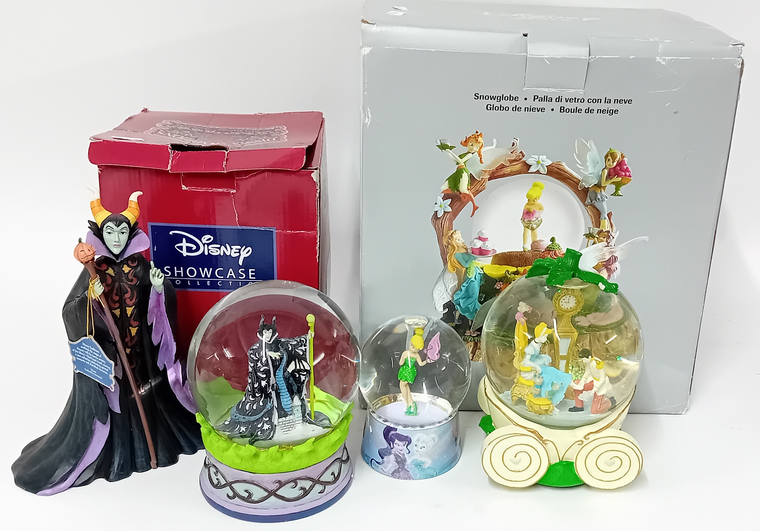 Disney, Disney tradition a collection of four snow globes, together with a figure of Maleficent.