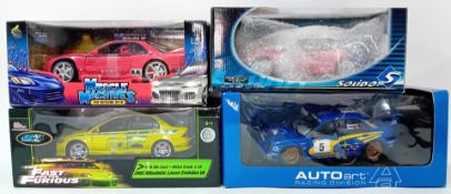 Four 1.18 scale race car models, to include Subaru 80191 Autoart, Fast and Furious Mitsubishi Lancer