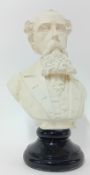 A plaster bust of Charles Dickens on a black stand, height 33cm.