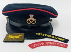 A WWII Officer's South Staffordshire cap, together with three formation patches. (4)