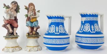 A pair of 19th century Corbridge jugs, together with a pair of bisqueware figures.