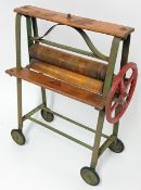 An early 20th century toy mangle by Tri-ang, wood rollers with painted metal frame, original painted